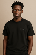 A young man wearing classic black designer t-shirt with white STARSTRUCK chest branding, featuring premium StarFlex fabric construction and minimalist streetwear design for everyday luxury