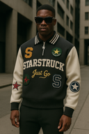Urban man wearing luxury black and cream designer varsity jacket with STARSTRUCK lettering, star patches, and premium StarFlex construction for streetwear fashion